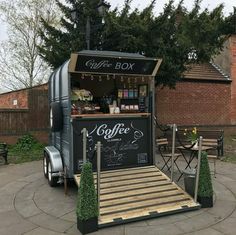 an old fashioned coffee box truck is parked in the middle of a circular patio area