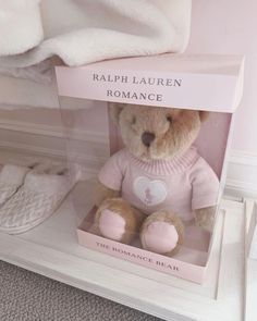 a teddy bear in a box with its name written on the front and back side