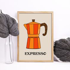 an orange coffee pot with the words expresso on it next to some yarns