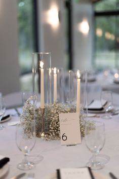 the table is set with candles and place cards