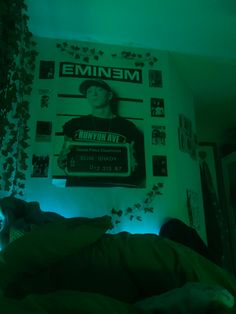 a person laying in bed under a green light