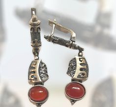 Exquisite handmade silver earrings with semi-precious stone and hieroglyphic carvings. Elegant Handmade Agate Earrings, Engraved Metal Earrings As Gift, Engraved Metal Earrings For Gift, Elegant Carnelian Earrings Gift, Elegant Carnelian Earrings For Gift, Elegant Agate Earrings As A Gift, Elegant Agate Earrings For Gift, Handmade Amber Agate Earrings, Elegant Silver Carved Earrings