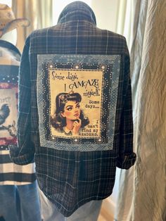 the back of a jacket with an image of a woman's face on it