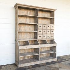 an old wooden bookcase with drawers on it