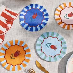 colorful plates and utensils laid out on a table