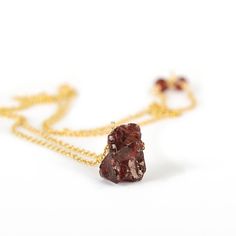 "The raw crystal necklace is made with rough garnet nugget centered and suspended from a delicate chain. High-quality metals and natural crystal, this necklace will be a gorgeous gift for your beloved born in January. Our bestseller! Matching earrings: https://etsy.me/2sAE7Mr M A T E R I A L S: * natural raw garnet, earth mined * 14k Gold Filled, 14k Rose Gold Filled or Sterling Silver (Available in 14k solid gold too! but without stones at the chain ends) * accented with tiny garnets at the cha Raw Stone Pendant Jewelry For Gifts, Raw Stone Pendant Jewelry As Gift, Fine Garnet Necklace For Gift, Fine Garnet Necklace As Gift, Fine Jewelry Garnet Necklace As Gift, Fine Jewelry Amber Necklaces As Gift, Elegant Necklace With Raw Stone And Mineral Crystal, Garnet Gemstone Pendant Necklaces, Amber Garnet Jewelry As Gift