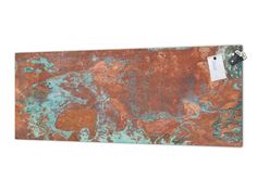 a rusted metal wall hanging on a white wall with a tag attached to it