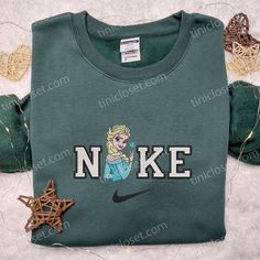 Elsa x Nike Embroidered Shirt, Disney Frozen Embroidered Hoodie, Best Gifts For Family Step into the enchanting world of Tinicloset, where creativity meets craftsmanship, and fashion becomes an extraordinary journey. Our store is a treasure trove of custom embroidered apparel that is not just clothing but a gateway to a realm of wonder and style. From the captivating Elsa x Nike embroidered shirt to the magical Disney embroidered shirts and the cozy Frozen embroidered hoodies, Tinicloset is your Embroidered Apparel, Maroon Hoodie, Embroidered Shirts, Fabric Markers, Hoodie Material, Embroidered Clothes, Blue Sweatshirt, Sons Birthday, Embroidered Hoodie