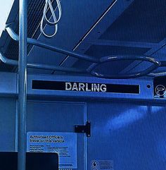 there is a sign that says daring on the back of a train car with blue walls