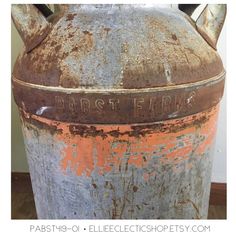 an old rusted metal tank with writing on it