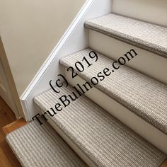 carpeted stairs leading up to the top floor