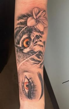 a woman's leg with tattoos on it and an eye in the center, which is