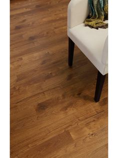 a white chair sitting on top of a hard wood floor