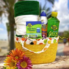 a basket filled with lots of different items on top of a wooden table next to a flower