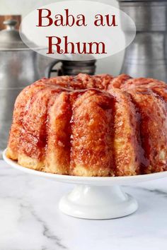 a bundt cake on a plate with the words baba au rhum above it