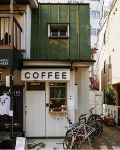 two bikes are parked in front of a coffee shop