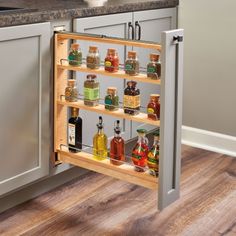 an open spice rack in the corner of a kitchen