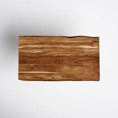 a wooden cutting board sitting on top of a white wall