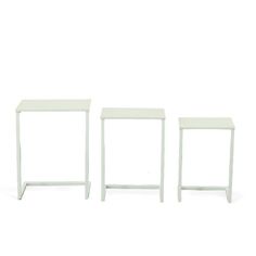 three small white tables sitting next to each other