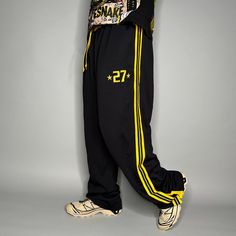 Vintage Skater Sweatpants Black Yellow Polyester Baggy Wide Leg Flare Buttons Y2K Skate / Streetwear Great Condition: 9/10 Men's Size: Large My Hands in Pockets = It has Pockets No Hands in Pockets = Does Not Have Pockets Drawstring Will be Visible in Forward Pic, if not Visible it Does Not Have a Drawstring About me: I am 6' 0" for reference I generally wear a Large (32" inseam) I Model XS to 2XL sweatpants, I find that you can often size up or down with 95% of sweatpants and they fit the same Baggy Sportswear Bottoms For Streetwear, Yellow Streetwear Pants With Pockets, Yellow Pants With Pockets For Streetwear, Baggy Sportswear Pants For Streetwear, Sporty Yellow Sweatpants For Streetwear, Casual Yellow Sweatpants For Streetwear, Yellow Sporty Sweatpants For Streetwear, Yellow Sweatpants With Pockets For Streetwear, Baggy Yellow Pants For Streetwear