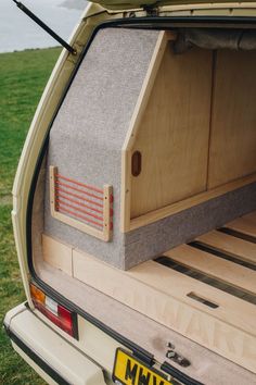 the back end of a car with its cargo compartment open and it's bed up