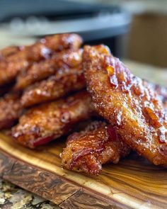 some kind of meat sitting on top of a wooden cutting board