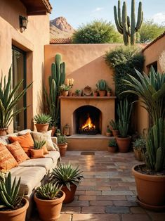 an outdoor patio with potted plants and a fire place in the middle of it