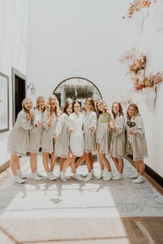 a group of women standing next to each other in front of a mirror on the floor