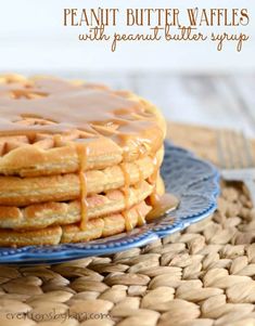 a stack of waffles with caramel drizzled on top sitting on a blue plate