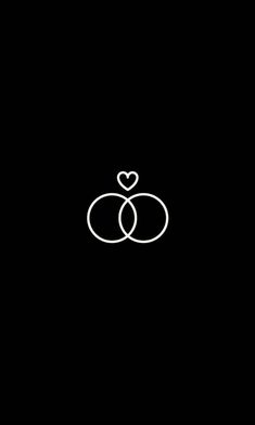 two rings with a heart in the middle on a black background that says, i love you