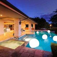 an outdoor pool with lights around it