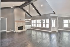 an empty living room with gray walls and wood flooring is pictured in this image