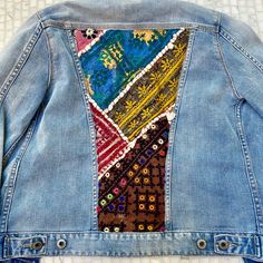 a denim jacket with colorful patches on the back