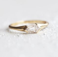 a gold ring with a white diamond in the middle