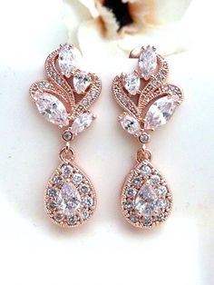 two pairs of earrings with diamonds on them