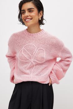 This sweater features an oversized fit and a stretchy, soft, loose knit material. It has a round neckline and ribbed hems. Chic Pink Fine Knit Sweater, Trendy Crew Neck Knit Top With Ribbed Cuffs, Oversized Pink Cropped Long Sleeve Sweater, Oversized Pink Long Sleeve Cropped Sweater, Pink Oversized Long Sleeve Cropped Sweater, Trendy Ribbed Crew Neck Sweater, Trendy Pink Cropped Sweater With Ribbed Cuffs, Pink Cropped Sweater With Ribbed Cuffs For Spring, Trendy Pink Cropped Knit Sweater