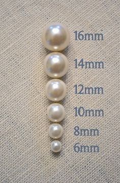 three white pearls are shown on the back of a piece of fabric with measurements for each pearl