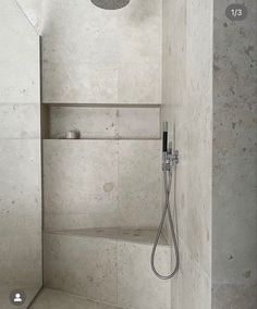 the shower head is mounted to the side of the wall in this modern style bathroom