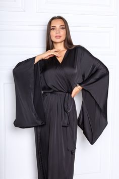 "This black silk satin robe is a kimono style robe with long wide sleeves. The robe is made of silk satin (Polyester -70%, viscosa-30%). The size of the robe on the photo is M (length is 142 cm / 56\"\"). The size and color can be chosen in the variations. What would you prefer elegance or comfort? It's probably hard to choose as even at home you want to look great and can relax after the busy day! That is why it's important to choose the right clothes. No matter if you are relaxing at home alon Bridal Kimono Robe, Long Silk Robe, Black Silk Robe, Black Satin Robe, Long Bridal Robe, Silk Bridal Robe, Silk Bridesmaid Robes, Silk Robe Long, Robe Silk