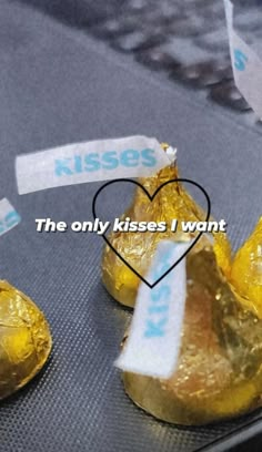 two pieces of foil wrapped in paper with the words kisses i want written on them