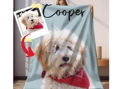 a white dog wearing a red shirt is on a blue blanket with the name cooper