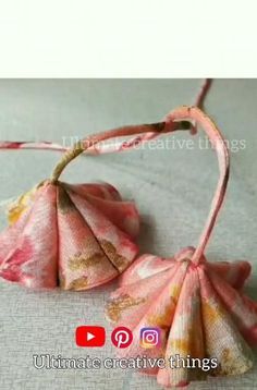 an origami flower is hanging from a string on a bed with the words ultimate creative things below it