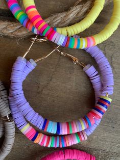 multicolored bracelets are displayed on a wooden surface