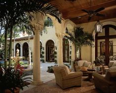 a living room filled with furniture and lots of windows