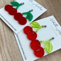 Love cherries? Bias a kpop idol that uses cherries as their symbol? Either way these cherry earrings are a fun way to show your love for the fruit or your bias! They measure about 1.5" at the widest point and have a drop of about 2".  The earrings are finished with stainless steel ball studs but if you require an alternative to make wearing them possible please reach out prior to placing an order. Be sure to check out Nikita Ashley Customs on Facebook, Instagram or our website - www.NikitaAshley Trendy Handmade Cherry Colored Earrings, Party Cherry Earrings, Trendy Handmade Cherry Earrings, Handmade Trendy Cherry Earrings, Cute Red Earrings With Fruit Design, Cute Fruit Design Drop Earrings, Trendy Cherry-colored Earrings, Laser Cut Jewelry Acrylic, Cherry Earrings