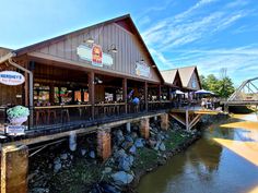 the outside of a restaurant next to a river