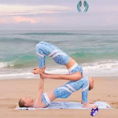 a woman is doing yoga on the beach