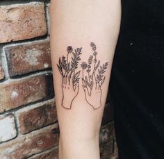 a person's arm with flowers on it and the words fearbear written in black ink