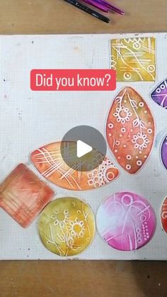 an image of some colorful rocks on a table with markers and pencils next to it