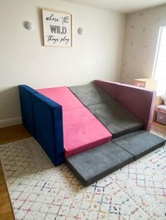 three different colored couches sitting on top of a rug